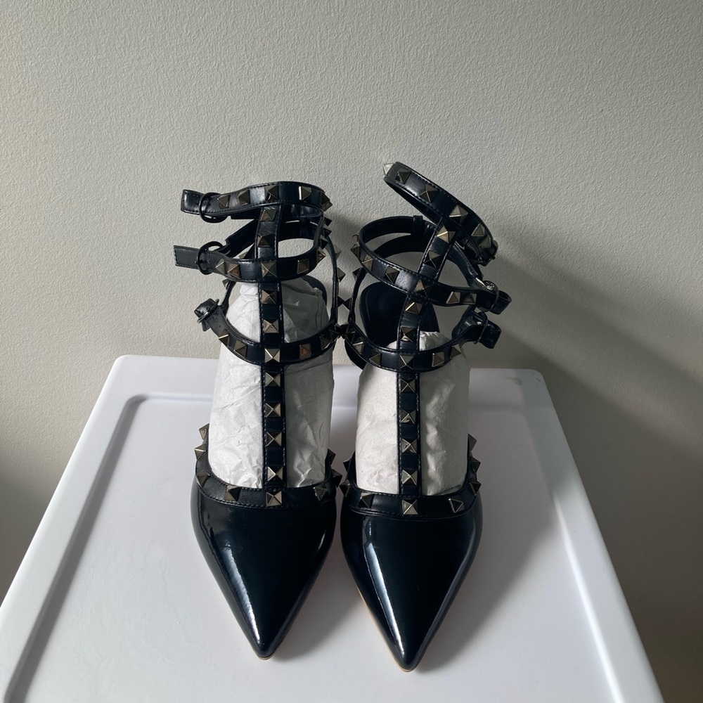 Valentino Garavani black patent Rockstud pumps.